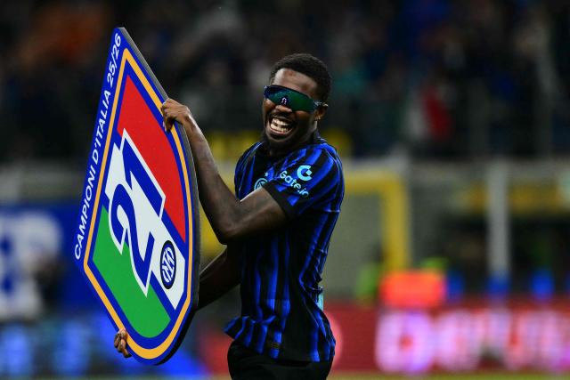 Inter Milan's French forward #9 Marcus Thuram celebrates with teammates after winning their 21st 'scudetto' following the Italian Serie A football match between Inter Milan and Parma at San Siro stadium in Milan, on May 3, 2026. (Photo by Stefano RELLANDINI / AFP)