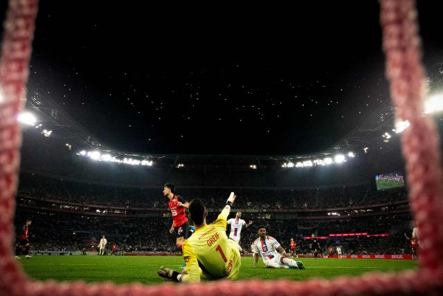 Lyon's Slovak goalkeeper #01 Dominik Greif (C) gestures after conceding a goal during the French L1 football match between Olympique Lyonnais and Rennes at the Groupama Stadium in Decines-Charpieu, central-eastern France, on May 3, 2026. (Photo by OLIVIER CHASSIGNOLE / AFP)
