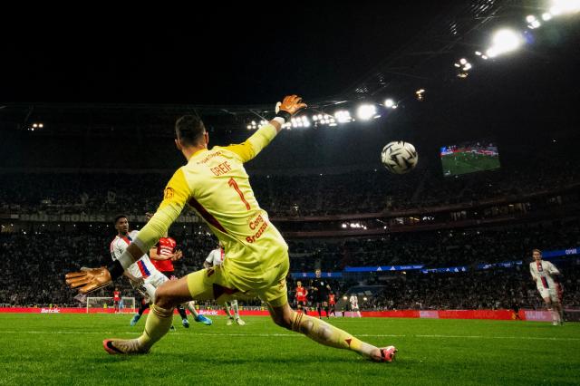 Lyon's Slovak goalkeeper #01 Dominik Greif (C) concedes rennes second goal during the French L1 football match between Olympique Lyonnais and Rennes at the Groupama Stadium in Decines-Charpieu, central-eastern France, on May 3, 2026. (Photo by OLIVIER CHASSIGNOLE / AFP)