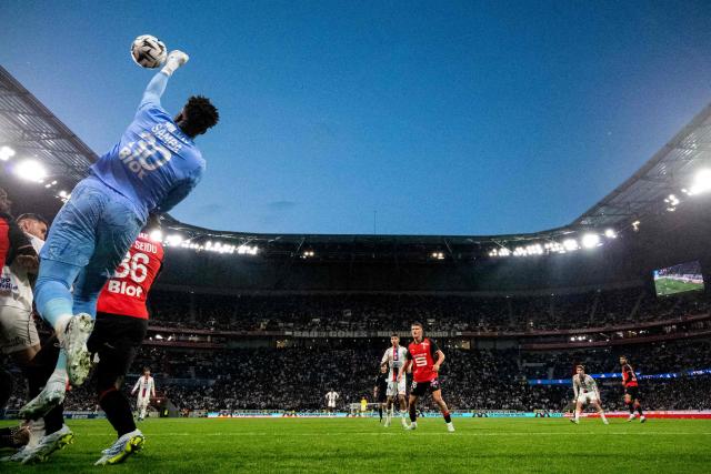 Rennes' French goalkeeper #30 Brice Samba (L) punches the ball during the French L1 football match between Olympique Lyonnais and Rennes at the Groupama Stadium in Decines-Charpieu, central-eastern France, on May 3, 2026. (Photo by OLIVIER CHASSIGNOLE / AFP)