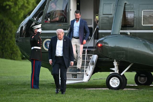US President Donald Trump and Donald Trump Jr. step off Marine One upon return to the White House in Washington, DC, on May 3, 2026. Trump spent the weekend at his Mar-a-Lago resort in Palm Beach, Florida and his Doral Miami resort. (Photo by Mandel NGAN / AFP)