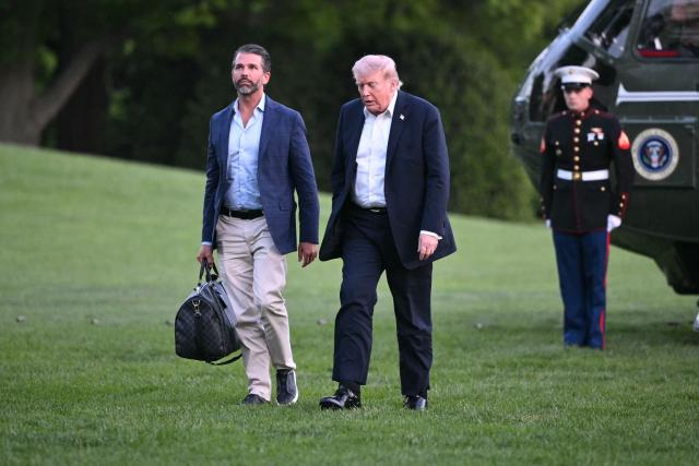 US President Donald Trump and Donald Trump Jr. walk toward the White House in Washington, DC, on May 3, 2026. Trump spent the weekend at his Mar-a-Lago resort in Palm Beach, Florida and his Doral Miami resort. (Photo by Mandel NGAN / AFP)