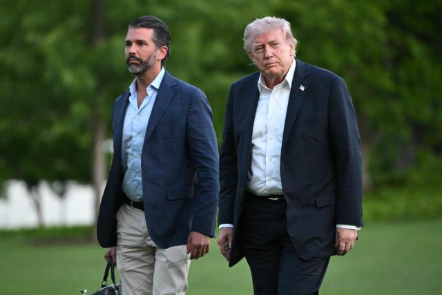 US President Donald Trump and Donald Trump Jr. walk on the south lawn toward the White House in Washington, DC, on May 3, 2026. Trump spent the weekend at his Mar-a-Lago resort in Palm Beach, Florida and his Doral Miami resort. (Photo by Mandel NGAN / AFP)