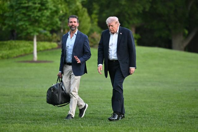 US President Donald Trump and Donald Trump Jr. walk on the south lawn toward the White House in Washington, DC, on May 3, 2026. Trump spent the weekend at his Mar-a-Lago resort in Palm Beach, Florida and his Doral Miami resort. (Photo by Mandel NGAN / AFP)