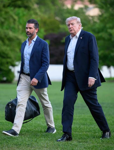 US President Donald Trump and Donald Trump Jr. walk on the south lawn toward the White House in Washington, DC, on May 3, 2026. Trump spent the weekend at his Mar-a-Lago resort in Palm Beach, Florida and his Doral Miami resort. (Photo by Mandel NGAN / AFP)