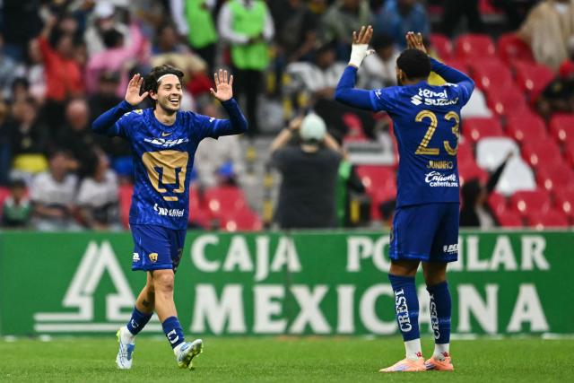 Pumas' midfielder #33 Jordan Carrillo celebrates with Pumas' Brazilian forward #23 Juninho Vieira after scoring during the Mexican League Clausura Tournament quarterfinal first leg football match between America and Pumas, at the Azteca stadium in Mexico City on May 3, 2026. (Photo by CARL DE SOUZA / AFP)