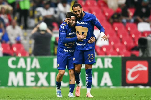 Pumas' midfielder #33 Jordan Carrillo celebrates with Pumas' Brazilian forward #23 Juninho Vieira after scoring during the Mexican League Clausura Tournament quarterfinal first leg football match between America and Pumas, at the Azteca stadium in Mexico City on May 3, 2026. (Photo by CARL DE SOUZA / AFP)