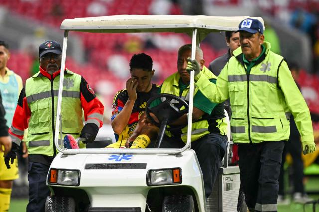 America's Uruguayan defender #04 Sebastian Caceres is driven off the field during the Mexican League Clausura Tournament quarterfinal first leg football match between America and Pumas, at the Azteca stadium in Mexico City on May 3, 2026. (Photo by CARL DE SOUZA / AFP)