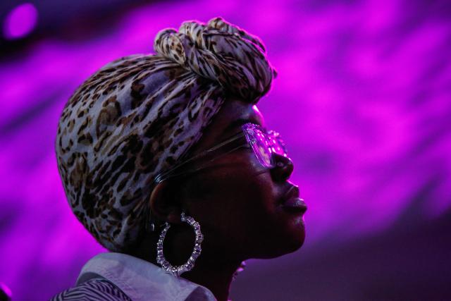 A participant watches "The People's Ball" at Brooklyn Public Library's Central Branch in Brooklyn, New York on May 3, 2026. "The People's Ball" offers an alternative to the Met Gala, allowing people to express their person styles. (Photo by kena betancur / AFP)