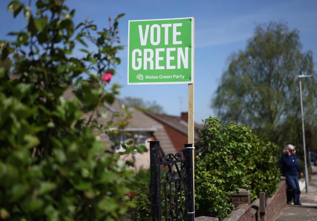 A Wales Green Party placard strapped to a garden gate ahead of the Senedd election in Cardiff, South Wales on April 23, 2026. Wales -- the cradle of Britain's revered National Health Service and a former industrial powerhouse -- has been a Labour Party stronghold for well over a century. But that is set to end in crunch polls next week as impatient Britons abandon their old political loyalties for anti-establishment parties amid persistent cost of living pressures. (Photo by Darren Staples / AFP) / TO GO WITH AFP STORY by Peter HUTCHISON