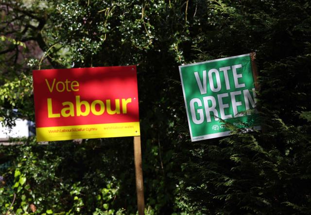 Wales Green Party and Labour Party placards outside homes ahead of the Senedd election in Cardiff, South Wales on April 23, 2026. Wales -- the cradle of Britain's revered National Health Service and a former industrial powerhouse -- has been a Labour Party stronghold for well over a century. But that is set to end in crunch polls next week as impatient Britons abandon their old political loyalties for anti-establishment parties amid persistent cost of living pressures. (Photo by Darren Staples / AFP) / TO GO WITH AFP STORY by Peter HUTCHISON