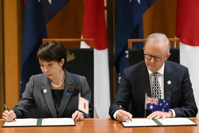 Japan's Prime Minister Sanae Takaichi (L) and Australia's Prime Minister Anthony Albanese take part in a signing ceremony for a joint declaration of economic security cooperation at Parliament House in Canberra on May 4, 2026. (Photo by Saeed Khan / AFP)