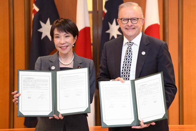 Japan's Prime Minister Sanae Takaichi (L) and Australia's Prime Minister Anthony Albanese pose with documents following a signing ceremony for a joint declaration of economic security cooperation at Parliament House in Canberra on May 4, 2026. (Photo by Saeed KHAN / AFP)