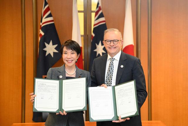 Japan's Prime Minister Sanae Takaichi (L) and Australia's Prime Minister Anthony Albanese pose with documents following a signing ceremony for a joint declaration of economic security cooperation at Parliament House in Canberra on May 4, 2026. (Photo by Saeed KHAN / AFP)