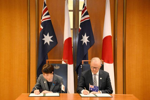 Japan's Prime Minister Sanae Takaichi (L) and Australia's Prime Minister Anthony Albanese take part in a signing ceremony for a joint declaration of economic security cooperation at Parliament House in Canberra on May 4, 2026. (Photo by Saeed KHAN / AFP)