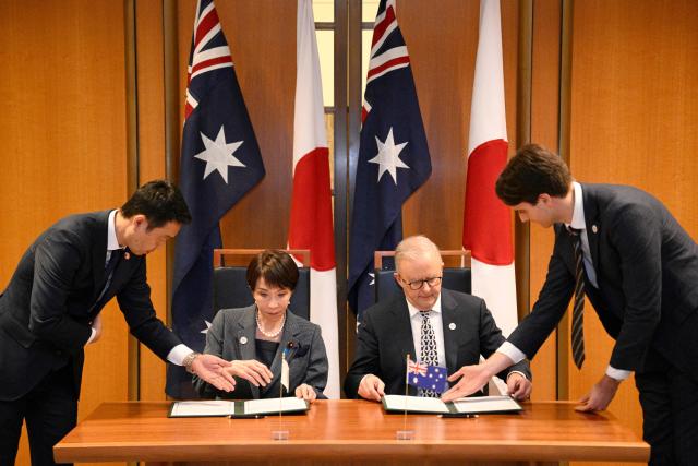 Japan's Prime Minister Sanae Takaichi (2nd L) and Australia's Prime Minister Anthony Albanese take part in a signing ceremony for a joint declaration of economic security cooperation at Parliament House in Canberra on May 4, 2026. (Photo by Saeed KHAN / AFP)