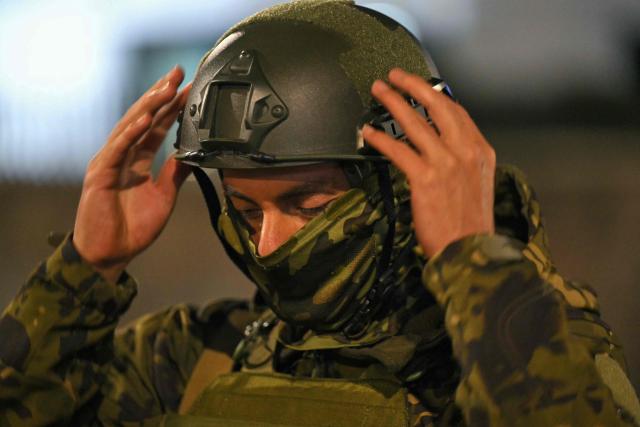 A member of the Ecuadorian military puts on a helmet following a curfew imposed by Ecuador’s President Daniel Noboa, at the San Jorge Military Fort in the Ruminahui canton, north of Quito, on May 3, 2026. (Photo by Rodrigo BUENDIA / AFP)