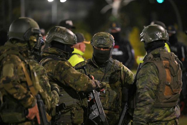 Members of Ecuadorian militar stand guard following a curfew imposed by Ecuador's President Daniel Noboa in Quito on May 3, 2026. (Photo by Rodrigo BUENDIA / AFP)