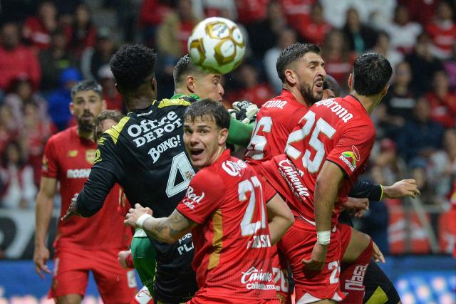 Pachuca's Brazilian defender #04 Eduardo Bauermann (L) and Toluca's Portuguese forward #26 Paulinho (2nd R) fight for the ball during the Mexican League Clausura Tournament quarterfinal first leg football match between Toluca and Pachuca at the Nemesio Diaz stadium in Toluca, Mexico, on May 3, 2026. (Photo by Mario Vazquez / AFP)