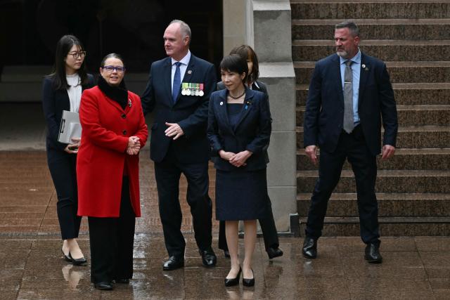 Japan's Prime Minister Sanae Takaichi (front 2nd R) visits the Australian War Memorial while accompanied by the memorial's director Matt Anderson (3rd L) in Canberra on May 4, 2026. (Photo by Saeed Khan / AFP)