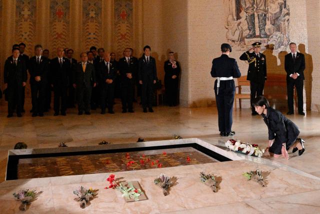 Japan's Prime Minister Sanae Takaichi lays a wreath at the Tomb of the Unknown Soldier during her visit to the Australian War Memorial in Canberra on May 4, 2026. (Photo by Saeed KHAN / AFP)