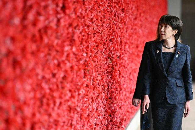 Japan's Prime Minister Sanae Takaichi (L) walks past poppies on the Roll of Honour during her visit to the Australian War Memorial in Canberra on May 4, 2026. (Photo by Saeed Khan / AFP)