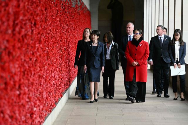 Japan's Prime Minister Sanae Takaichi (L) walks past poppies on the Roll of Honour during her visit to the Australian War Memorial in Canberra on May 4, 2026. (Photo by Saeed Khan / AFP)