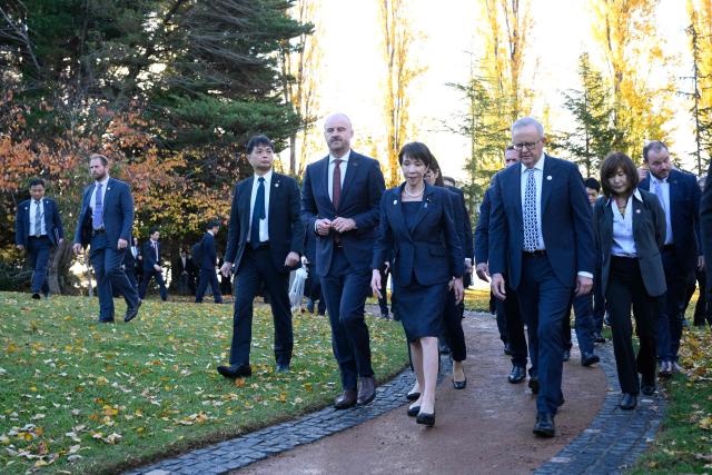Japan's Prime Minister Sanae Takaichi (C), Australia's Prime Minister Anthony Albanese (front R), and Australian Capital Territory Chief Minister Andrew Barr (front L) leave after taking part in a tree planting ceremony at the Canberra Nara Peace Park in Canberra on May 4, 2026. (Photo by Saeed KHAN / AFP)