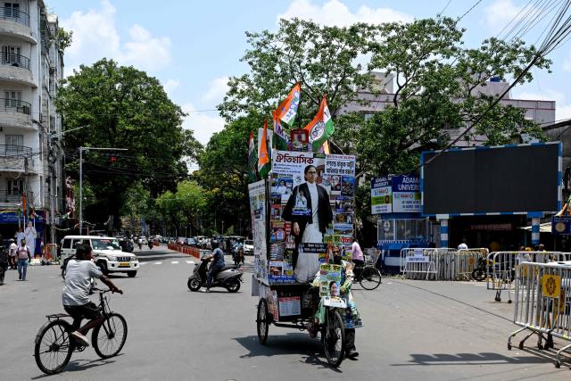 An All India Trinamool Congress (TMC) party supporter pulls a cycle van decorated with a cut-out of West Bengal chief minister and party chairperson Mamata Banerjee, along a street near her residence in Kolkata on May 4, 2026 during vote counting for the West Bengal Legislative Assembly elections. Vote counting in key Indian state elections was underway on May 4 under tight security, with the focus on West Bengal, where Prime Minister Narendra Modi's party is hoping for crucial gains. (Photo by Dibyangshu SARKAR / AFP)