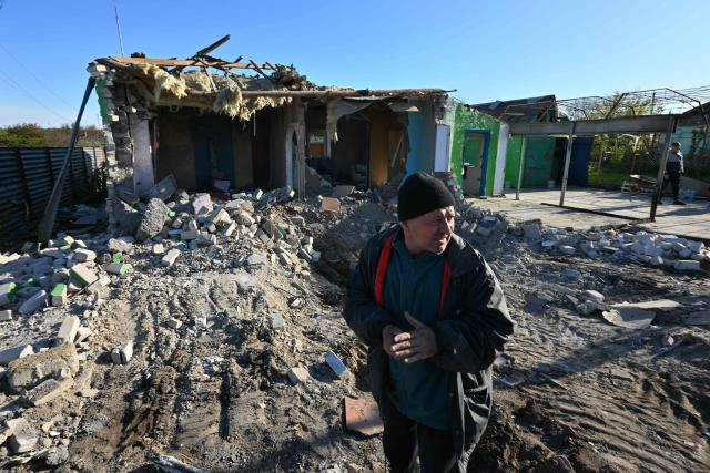 Local residents clear debris of a house destroyed by a recent drone attack in the settlement of Stariy Krym in the Donetsk region, Russian-controlled Ukraine, on May 3, 2026, amid the ongoing Russian-Ukrainian conflict. (Photo by AFP)