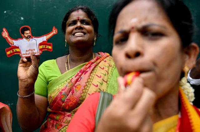 Tamilaga Vettri Kazhagam (TVK) party members blow a whistle (party symbol) and hold a cut-out of Indian actor and party president C. Joseph Vijay to celebrate during vote counting for the Tamil Nadu Legislative Assembly elections, at the party headquarters in Chennai on May 4, 2026. Vote counting in key Indian state elections was underway on May 4 under tight security with veteran politician MK Stalin trailing in the southern state of Tamil Nadu, challenged by a political debutante -- film star C. Joseph Vijay. (Photo by R. Satish BABU / AFP)