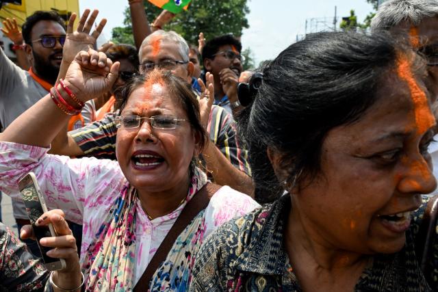 Bharatiya Janata Party (BJP) supporters celebrate near the residence of West Bengal chief minister and All India Trinamool Congress (TMC) party chairperson Mamata Banerjee, along a street near her residence in Kolkata on May 4, 2026 during vote counting for the West Bengal Legislative Assembly elections. Vote counting in key Indian state elections was underway on May 4 under tight security, with the focus on West Bengal, where Prime Minister Narendra Modi's party appeared set for victory. (Photo by Dibyangshu SARKAR / AFP)
