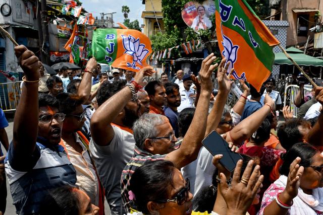 Bharatiya Janata Party (BJP) supporters celebrate along a street near her residence of West Bengal chief minister and All India Trinamool Congress (TMC) party chairperson Mamata Banerjee, in Kolkata on May 4, 2026 during vote counting for the West Bengal Legislative Assembly elections. Vote counting in key Indian state elections was underway on May 4 under tight security, with the focus on West Bengal, where Prime Minister Narendra Modi's party appeared set for victory. (Photo by Dibyangshu SARKAR / AFP)