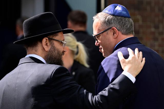 Rabbi Yehuda Teichtal (L) welcomes Thuringia's State Premier Mario Voigt as he arrives in front of the Chabad Synagogue in Berlin, Germany, where the leadership of his Christian Democratic Union (CDU) party meets on May 4, 2026. (Photo by Tobias SCHWARZ / AFP)