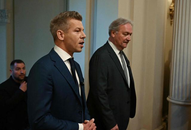 The leader of Hungary's Tisza Party, Prime Minister elect Peter Magyar (C) arrives with the President of the Hungarian Academy of Sciences (MTA) Tamas Freund (R) at the headquarters of MTA in Budapest, Hungary, on May 4, 2026. The event marked the 200th anniversary of the Hungarian Academy of Sciences, celebrating two centuries of Hungarian scientific tradition and its future mission. (Photo by Attila KISBENEDEK / AFP)