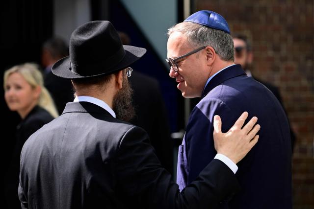 Rabbi Yehuda Teichtal (L) welcomes Thuringia's State Premier Mario Voigt as he arrives in front of the Chabad Synagogue in Berlin, Germany, where the leadership of his Christian Democratic Union (CDU) party meets on May 4, 2026. (Photo by Tobias SCHWARZ / AFP)
