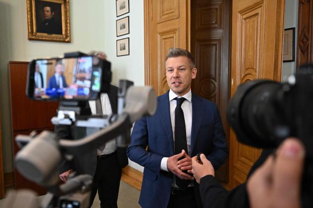 The leader of Hungary's Tisza Party, Prime Minister elect Peter Magyar (C) speaks with journalists at the Hungarian Academy of Sciences (MTA) in Budapest, Hungary, on May 4, 2026, during celebrations to mark the institution's 200th anniversary. (Photo by Attila KISBENEDEK / AFP)