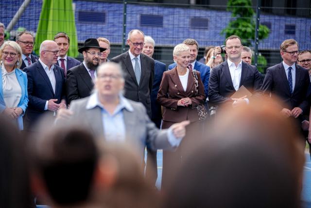 (2nd L to R) Berlin's mayor Kai Wegner, Rabbi Yehuda Teichtal, German Chancellor Friedrich Merz, and CDU politicians Silvia Breher, Jens Spahn and Carsten Linnemann greet schoolchildren at the Pears Jewish Campus of the Chabad Jewish Community in Berlin, Germany, where the leadership of Merz' conservative Christian Democratic Union (CDU) party meets on May 4, 2026. (Photo by Kay Nietfeld / POOL / AFP)