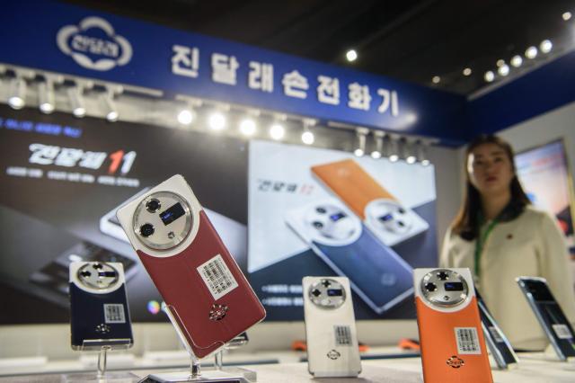 Domestically produced Jindallae mobile phones are displayed at a stall during the 24th Pyongyang Spring International Trade Fair opening at the Central Youth Hall in Pyongyang on May 4, 2026. (Photo by KIM Won Jin / AFP)