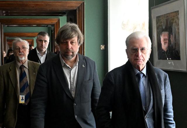Russian archaeologist Alexander Butyagin, the head of the archaeology department at the Hermitage Museum who was arrested last December in Poland and wanted in Ukraine for conducting excavations in Crimea, accompanied by Director of the State Hermitage Museum Mikhail Piotrovsky, arrives to hold a press conference after being freed in the last week's US-brokered deal on prisoners exchange between Belarus and European countries, at the State Hermitage Museum in Saint Petersburg on May 4, 2026. (Photo by Olga MALTSEVA / AFP)