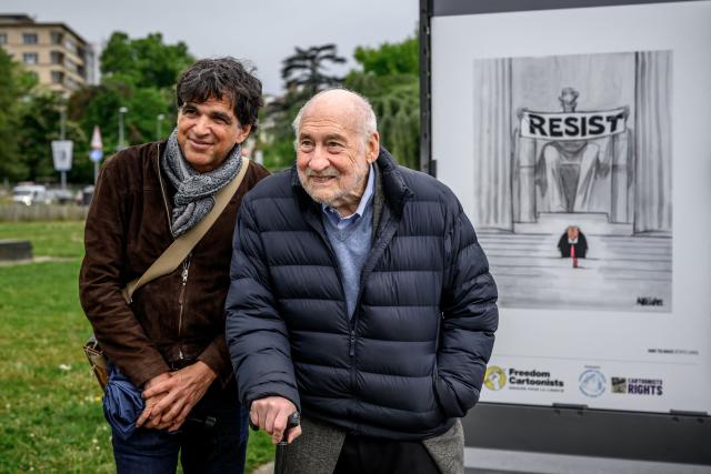 US Nobel Prize–winning economist Joseph Stiglitz (R) and Swiss editorial cartoonist Patrick Chappatte (L) visit the exhibition “Dessins pour la libertй” (“Drawings for Freedom”), held to mark World Press Freedom Day on the shores of Lake Geneva in Geneva on May 4, 2026. (Photo by Fabrice COFFRINI / AFP)