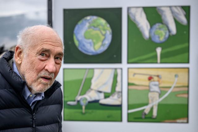 US Nobel Prize–winning economist Joseph Stiglitz looks on next to a cartoon by US alternative comics artist and illustrator Kuper during his visit to the exhibition “Dessins pour la libertй” (“Drawings for Freedom”), held to mark World Press Freedom Day on the shores of Lake Geneva in Geneva on May 4, 2026. (Photo by Fabrice COFFRINI / AFP)