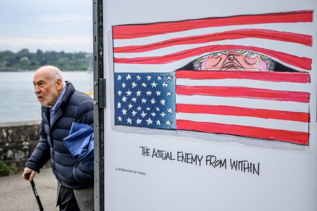 US Nobel Prize–winning economist Joseph Stiglitz walks past a cartoon by US editorial cartoonist Ann Telnaes during his visit to the exhibition “Dessins pour la libertй” (“Drawings for Freedom”), held to mark World Press Freedom Day on the shores of Lake Geneva in Geneva on May 4, 2026. (Photo by Fabrice COFFRINI / AFP)