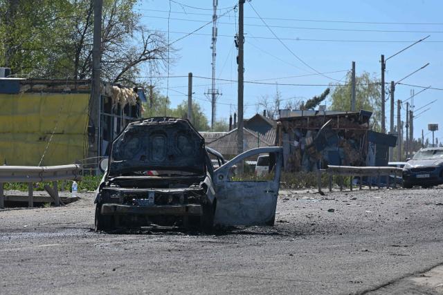 This photograph shows a damaged car at the site of a Russian missile strike in the town of Merefa, Kharkiv region, on May 4, 2026, amid the Russian invasion of Ukraine. The strike hit the town of Merefa, which has faced heavy attacks by Russia in the more than four years of its invasion. (Photo by SERGEY BOBOK / AFP)