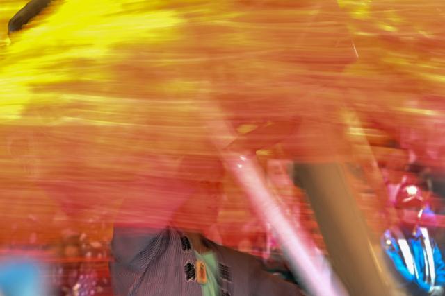 A festival participant spins an elaborate three-meter-tall decorated lantern tower known as Mant? through the streets of Fuchu during the Kurayami Matsuri, or "Festival of Darkness," at Okunitama Shrine in western Tokyo on May 4, 2026, as neighbourhood groups compete in an ancient tradition to keep their 50-kilogram towers twirling the longest while judges assess the artistry of each team's decorated pole. (Photo by Andrew CABALLERO-REYNOLDS / AFP)