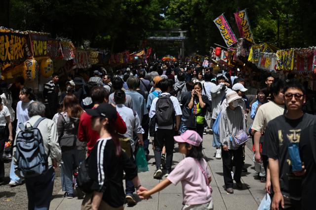 Crowds pack the grounds of Okunitama Shrine in Fuchu, western Tokyo on May 4, 2026, as they browse food stalls during the Kurayami Matsuri festival, as nearly 24 million people are expected to travel during Golden Week, the country's busiest holiday period, with travel peaking on May 5 and 6 as people return to the major urban centres. (Photo by Andrew CABALLERO-REYNOLDS / AFP)