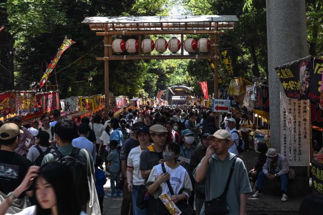 Crowds pack the grounds of Okunitama Shrine in Fuchu, western Tokyo on May 4, 2026, as they browse food stalls during the Kurayami Matsuri festival, as nearly 24 million people are expected to travel during Golden Week, the country's busiest holiday period, with travel peaking on May 5 and 6 as people return to the major urban centres. (Photo by Andrew CABALLERO-REYNOLDS / AFP)