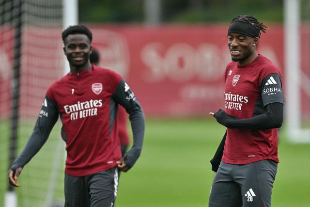 Arsenal's English midfielder #07 Bukayo Saka (L) and Arsenal's English midfielder #20 Noni Madueke (R) take part in a team training session at London Colney, north of London, on May 4, 2026, on the eve of their UEFA Champions League, semi-final, second-leg football match against Atletico Madrid. (Photo by Glyn KIRK / AFP)