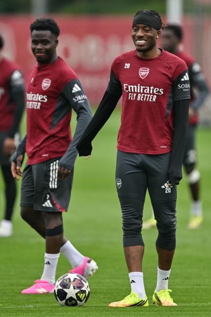 Arsenal's English midfielder #07 Bukayo Saka (L) and Arsenal's English midfielder #20 Noni Madueke (R) take part in a team training session at London Colney, north of London, on May 4, 2026, on the eve of their UEFA Champions League, semi-final, second-leg football match against Atletico Madrid. (Photo by Glyn KIRK / AFP)
