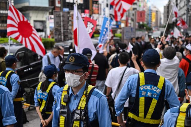Police look on as they form a line between a nationalist rally and counter-protesters near Ikebukuro Station in Tokyo's Toshima district on May 4, 2026, where participants called for stricter immigration controls and denounced the Japan Communist Party. (Photo by Andrew CABALLERO-REYNOLDS / AFP)